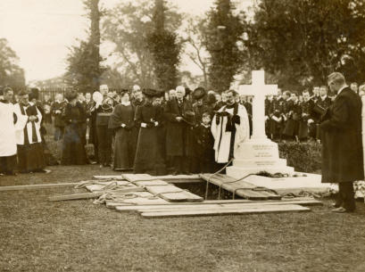 Relatives at the graveside at the clergyman reading burial service