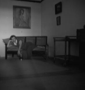 35 Agil Building  S.E Compound.  Oct Smith on sofa.  12.2.54 (Not in focus)