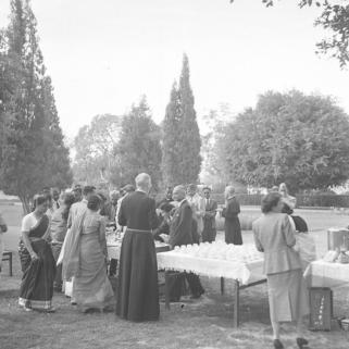 Father Clayton at tea table with congregation at his farewell.  13.2.54