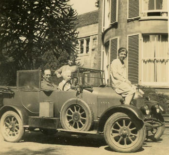 Harry (driver) and Helen (standing) Hannay, Mary Emma Polland (passenger seat) and Ruth (sitting on bonnet).  Wicklaw Grange, Chalford 
